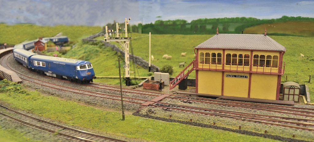 Blue Pullman diesel train passing the signal box.